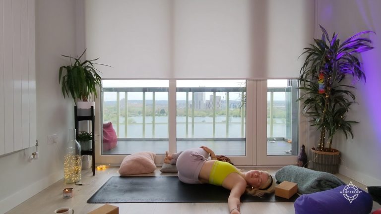 Woman doing yoga in front of windows
